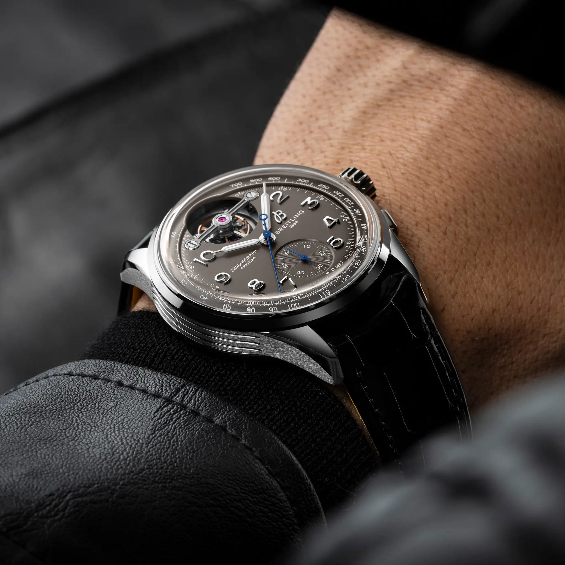Breitling Premier B21 Chronograph Tourbillon 42 Gaston Breitling reference JB2120A61B1P1 with Anthracite dial, 18k white gold case, alligator strap, on-wrist view