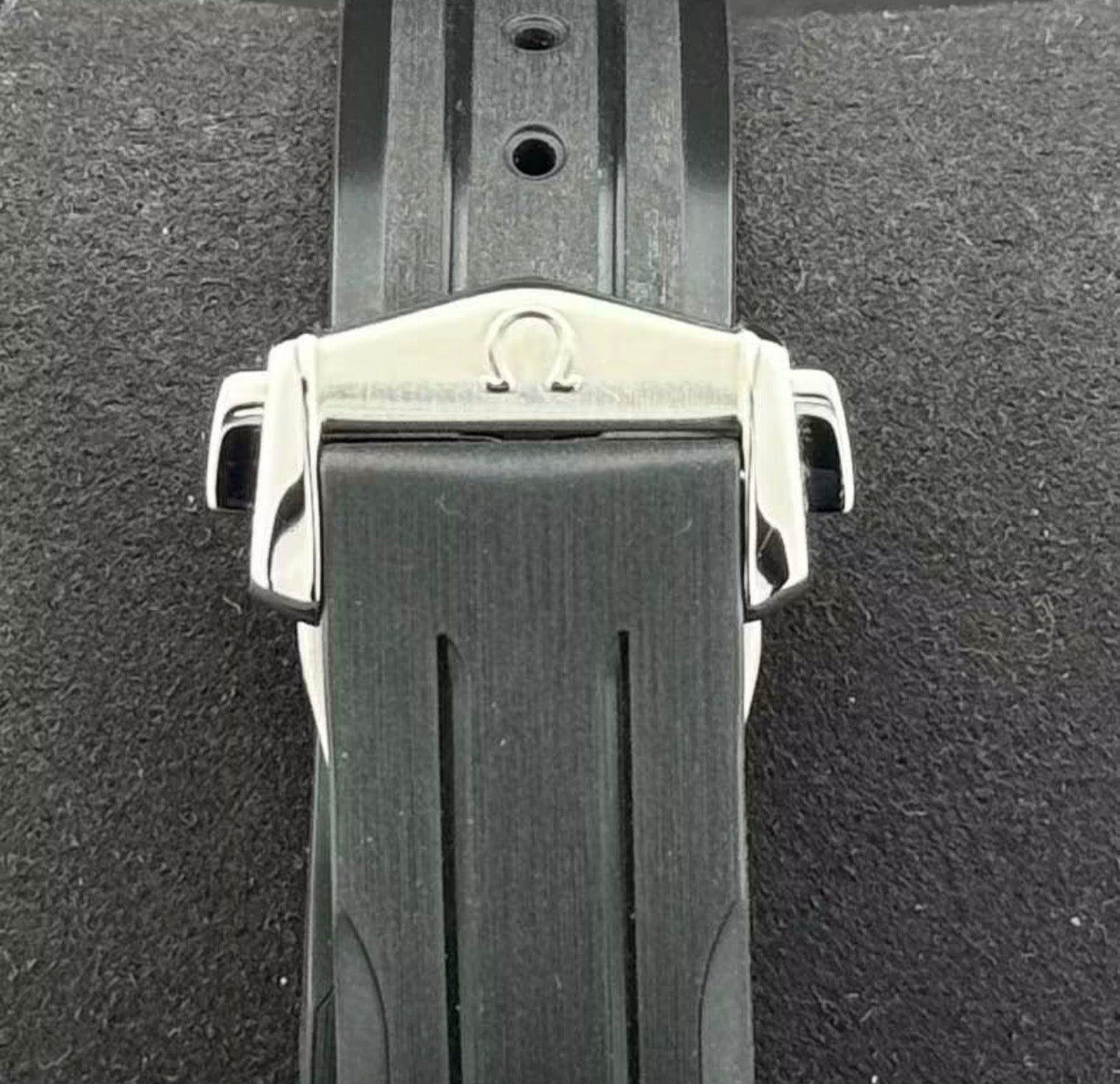 Omega Speedmaster Moonwatch Professional black perforated leather strap and stainless-steel deployant clasp detail