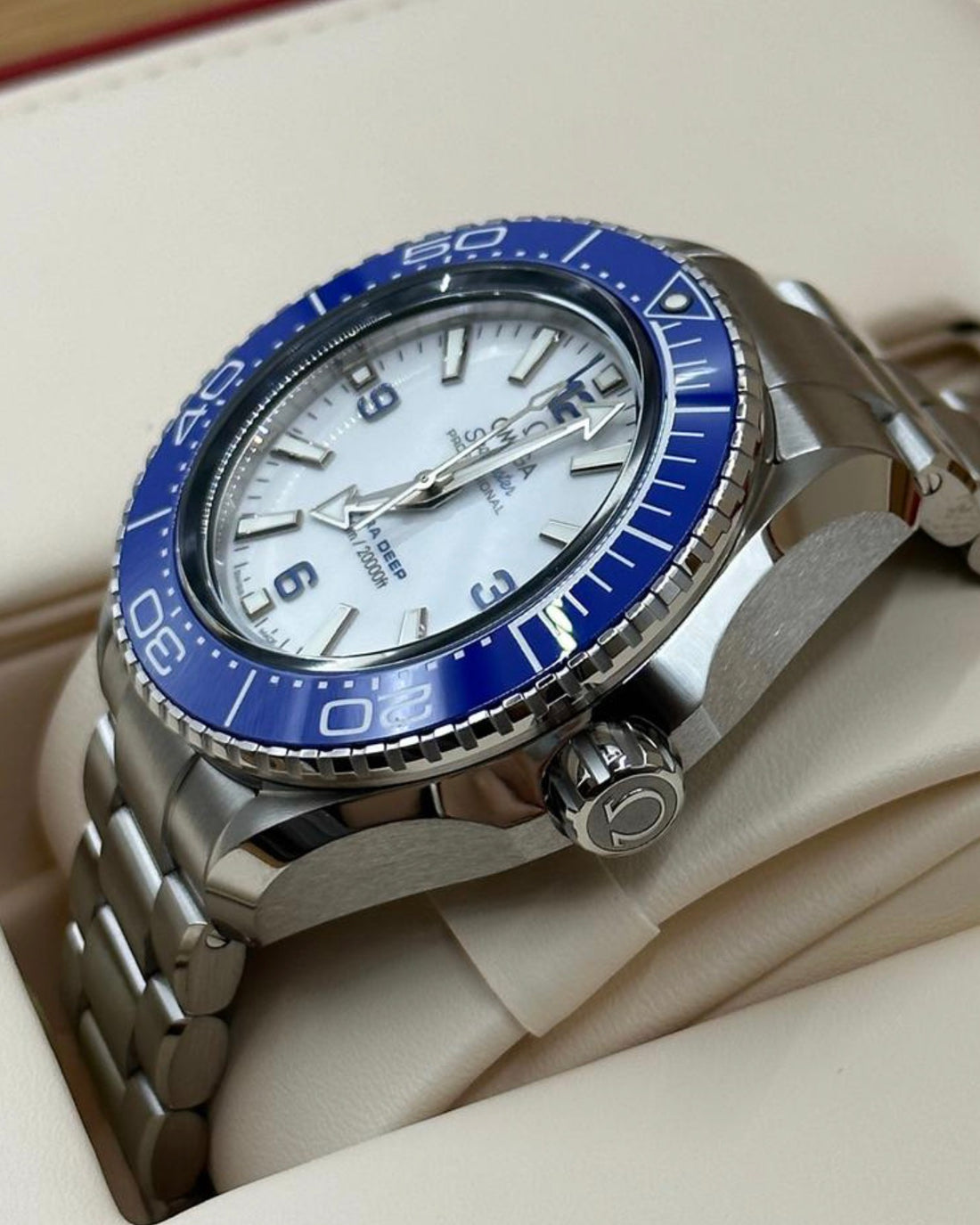 Crown-side view of Omega Ultra Deep 215.30.46.21.04.001 O-MEGASTEEL case and blue ceramic bezel
