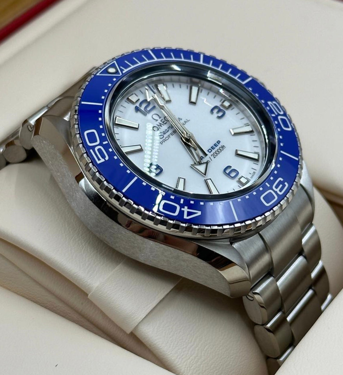 Angled view of Omega Ultra Deep 215.30.46.21.04.001 white dial and O-MEGASTEEL bracelet
