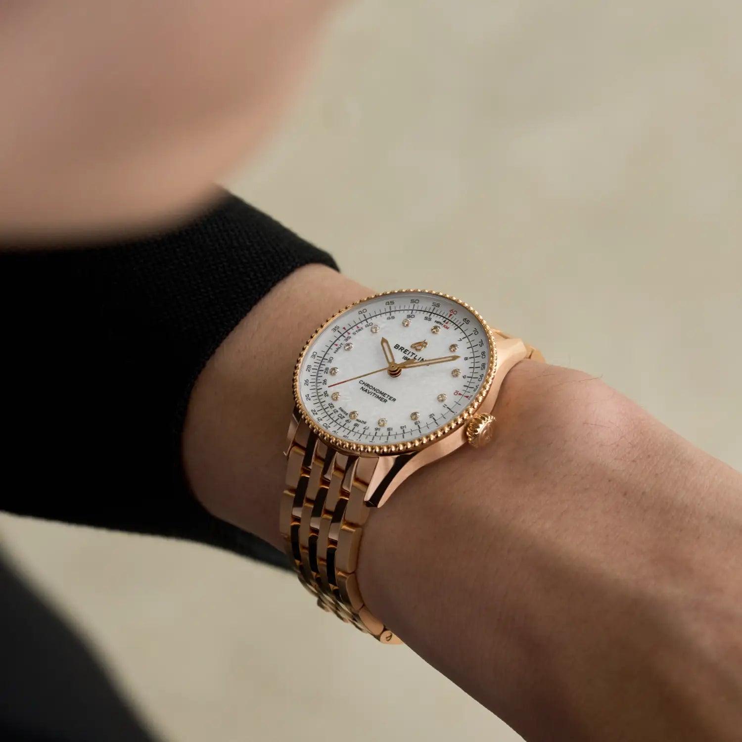 Breitling Navitimer Automatic 36 reference R17327211A1R1 with Mother-of-pearl dial, Small scale traceable 18K red gold case, bracelet, on-wrist view