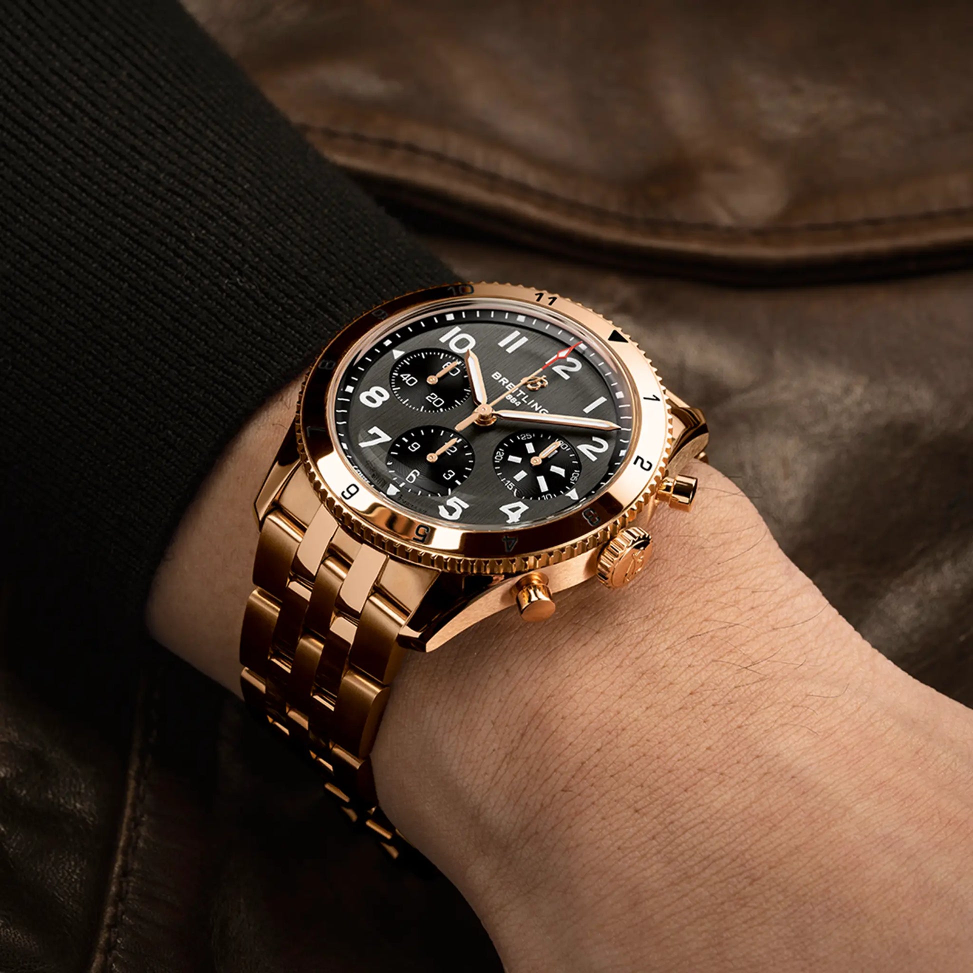Breitling Classic AVI Chronograph 42 P-51 Mustang reference R233801A1B1R1 with Black dial, 18k red gold case, bracelet, on-wrist view