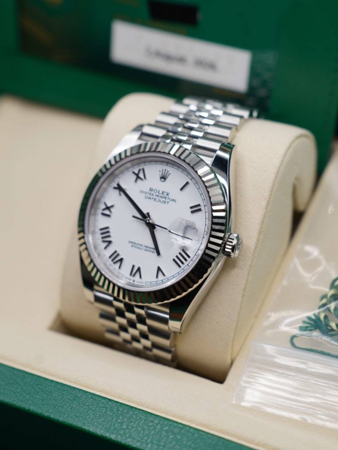 Angled crown-side view of Rolex Datejust 41 126334-0036 showing white Roman dial and fluted bezel
