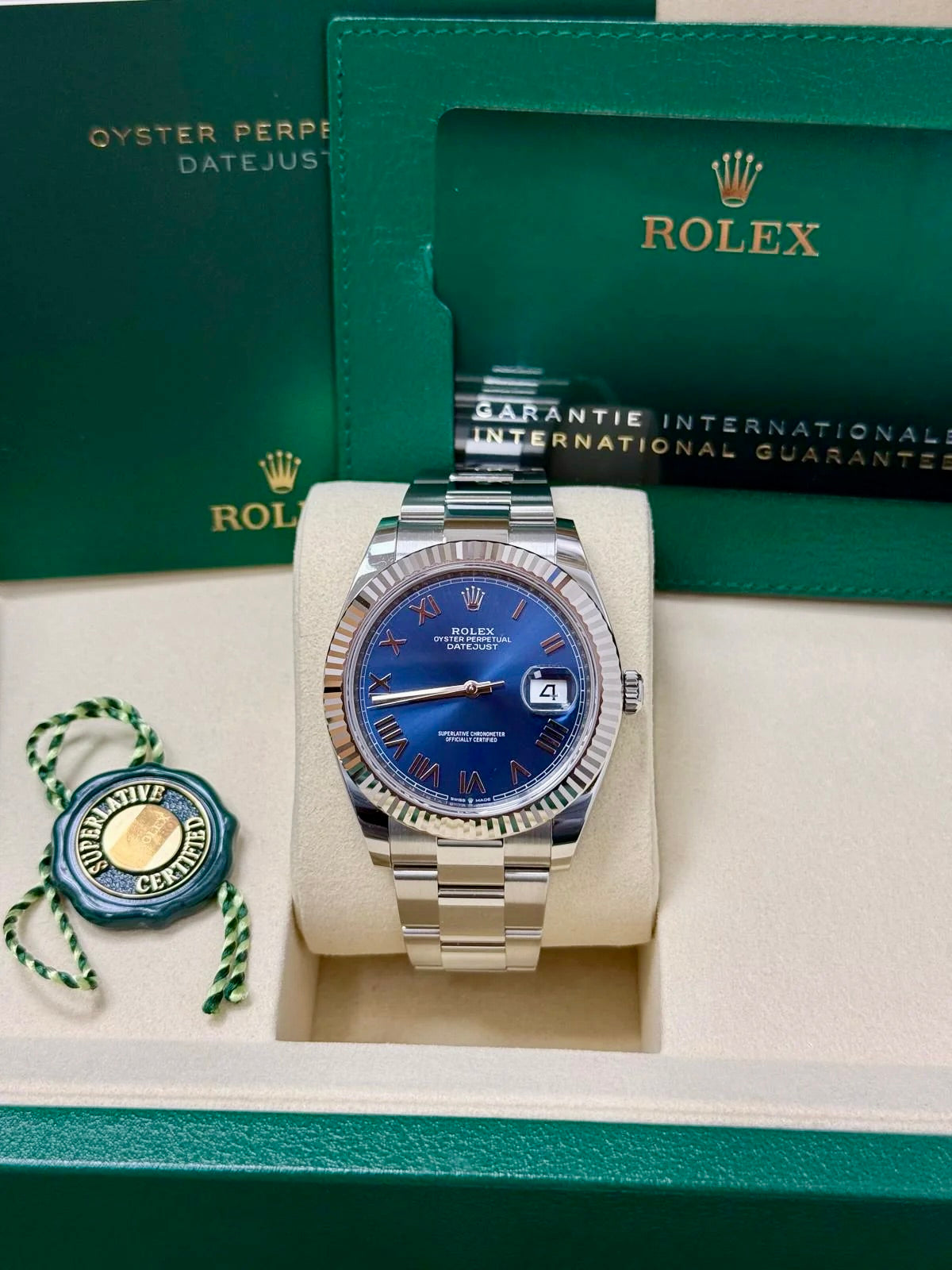 Unworn 2026 Rolex Datejust 41 126334-0037, new bright blue Roman dial, fluted bezel and Oyster bracelet — watch in presentation box