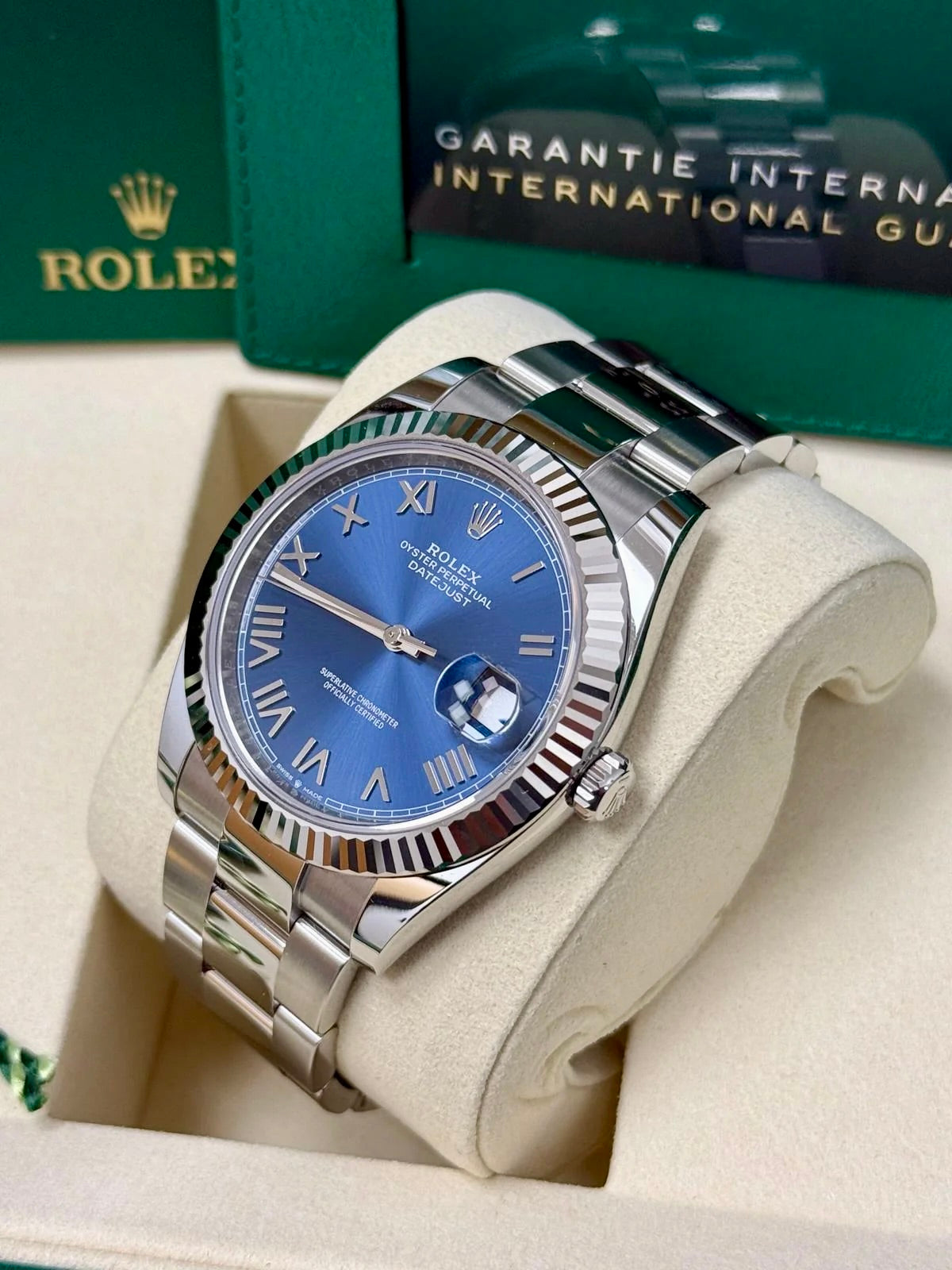 Unworn 2026 Rolex Datejust 41 126334-0037, new bright blue Roman dial, fluted bezel and Oyster bracelet — angled crown-side view
