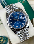 Rolex Datejust 41 126334 diagonal close-up with blue diamond-set dial, fluted bezel and Jubilee bracelet beside Rolex hangtags