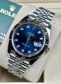 Rolex Datejust 41 126334 opposite diagonal close-up with blue diamond-set dial, fluted bezel and Jubilee bracelet beside Rolex booklet