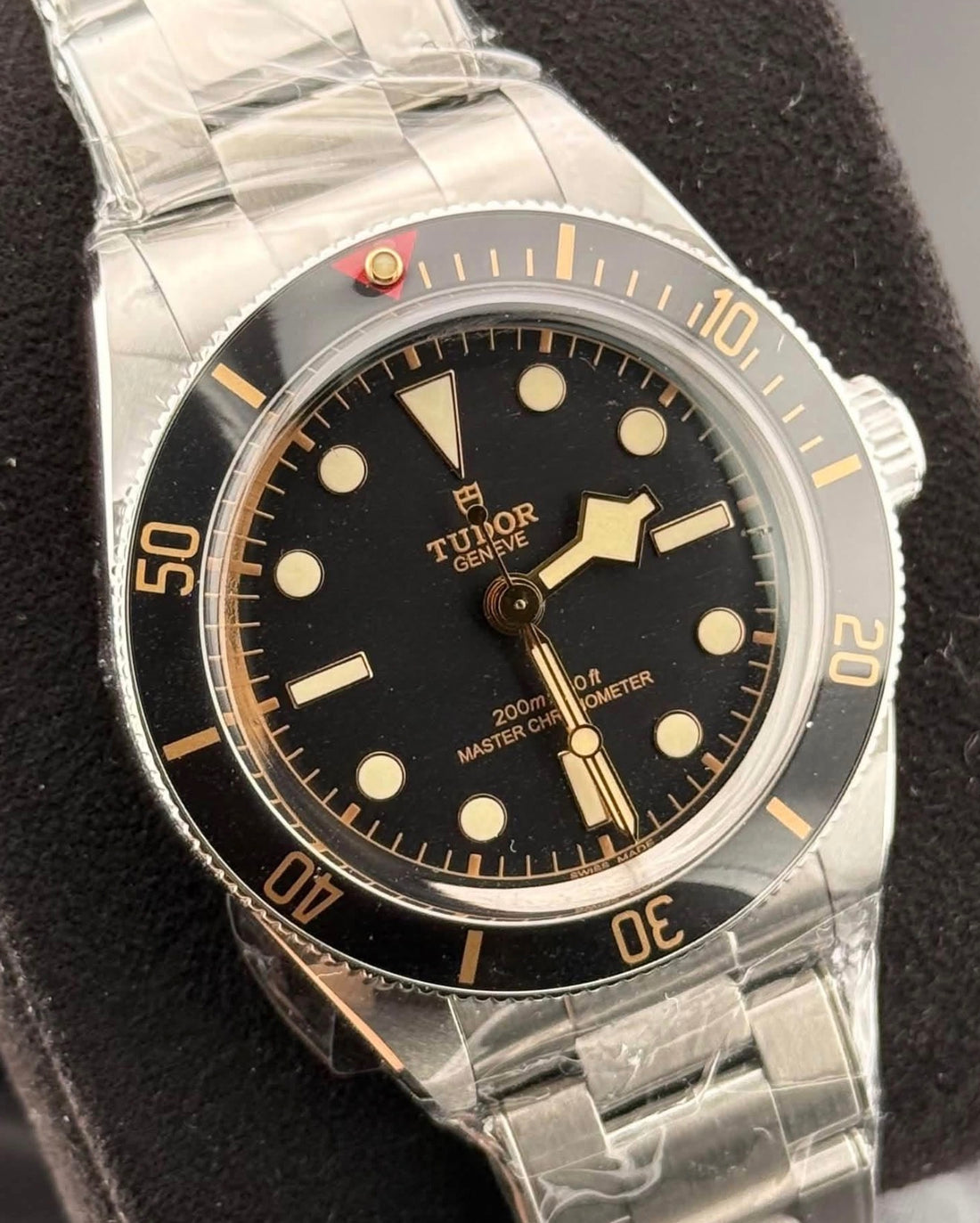 Angled close-up of Tudor Black Bay 58 black dial, gilt accents and black diving bezel