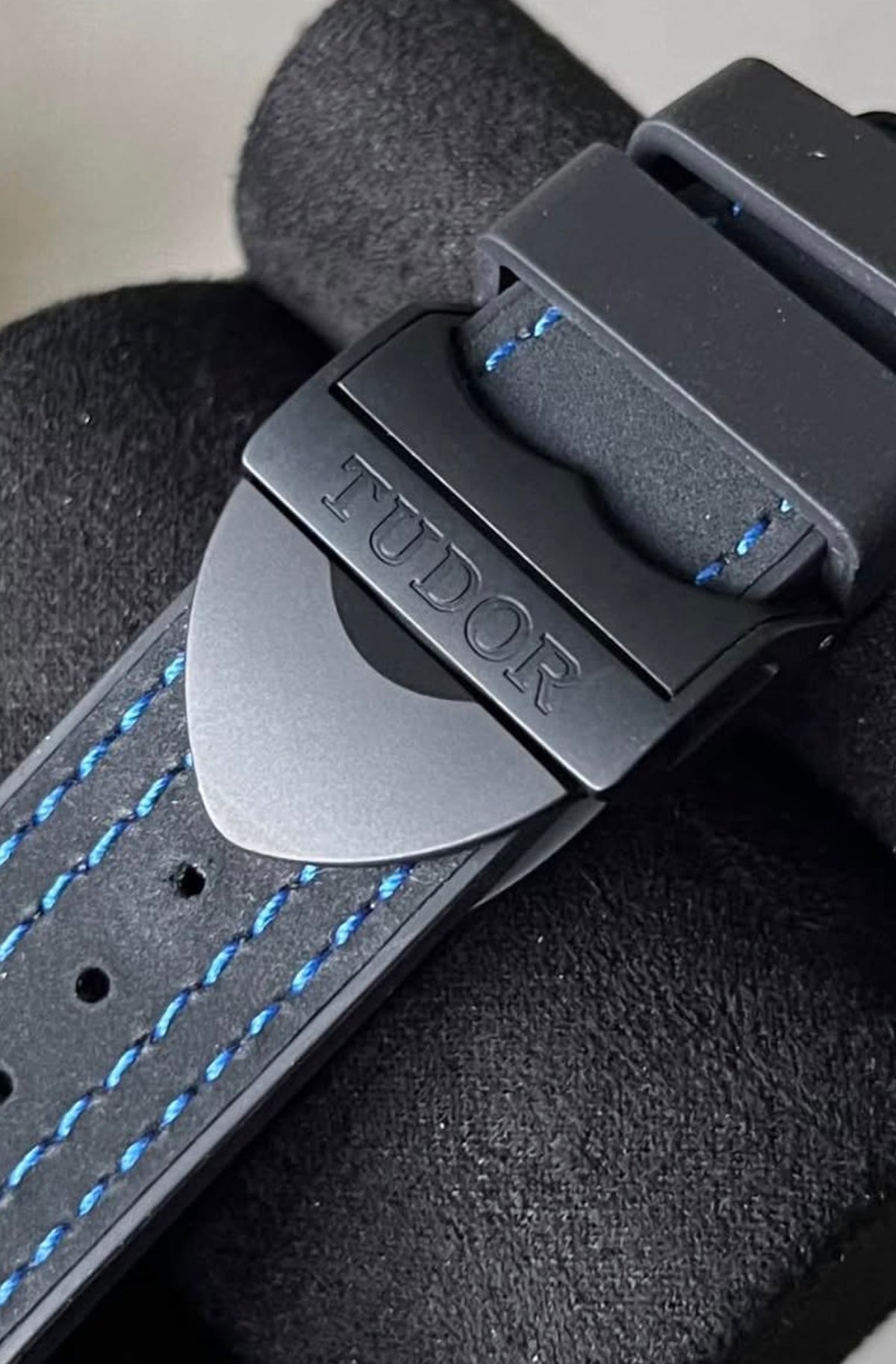 Black PVD-treated Tudor folding clasp and blue stitching on the Black Bay Ceramic Blue hybrid strap