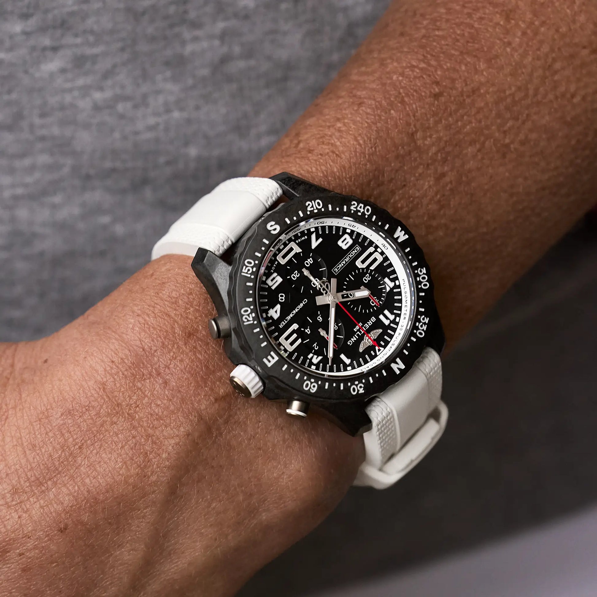 Breitling Endurance Pro 38 reference X83310A71B1S1 with Black dial, Breitlight® case, white rubber strap, on-wrist view